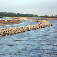 Stenen dam op de oever van een waterloop