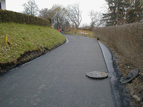 New road without an asphalt surface, with a manhole
