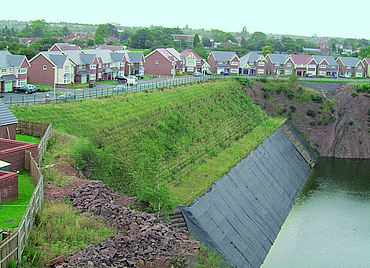 Aerial view of the completed building site with houses in the background