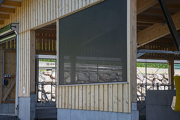 Close-up view of a geotextile tensioning system installed in a dairy cow barn